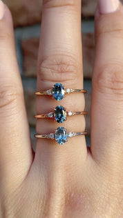 Three Estel Ring featuring a 0.60ct blue-green oval Montana sapphire and natural diamond accents in 14k solid gold