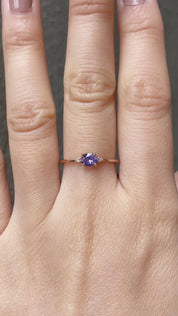 The Emilie 0.45ct Umba purple sapphire ring worn to show the unique horizontal orientation and rose gold band on hand.