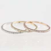 Three slim Meteor Diamond Bands in white, yellow, and rose gold, each with natural white diamonds set around the band