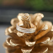 Close-up of Meteor Diamond Band 1.3mm with natural white diamonds on a gold-painted pinecone background