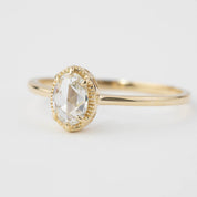 Close-up of Ava Ring featuring an oval rose cut diamond set in a delicate recycled gold band with six prongs