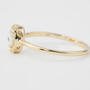 Side view of Ava Ring with oval rose cut diamond set in a low profile six prong gold bezel setting