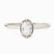 Oval rose cut diamond ring with six-prong bezel setting on a tapered recycled metal band in white gold