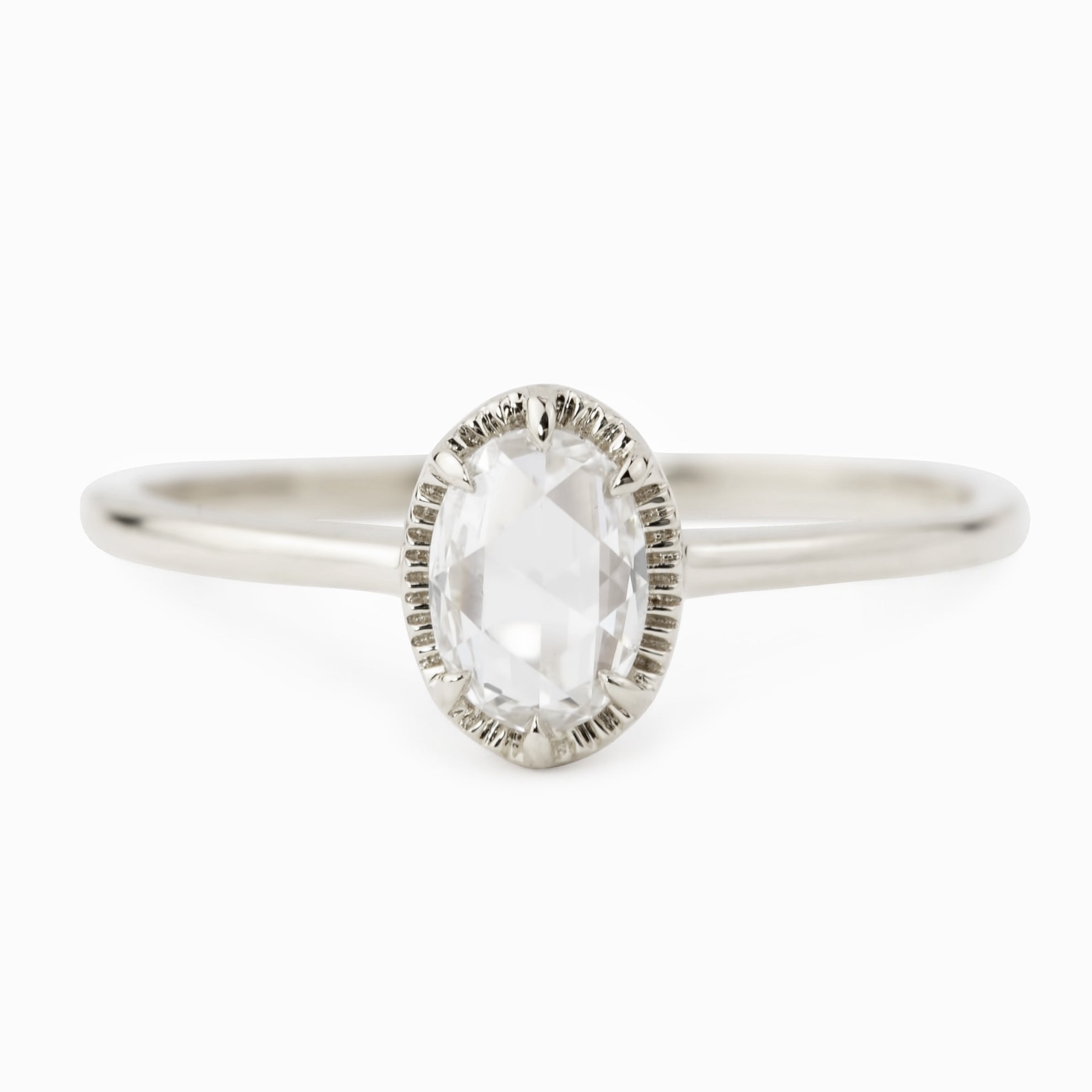 Oval rose cut diamond ring with six-prong bezel setting on a tapered recycled metal band in white gold