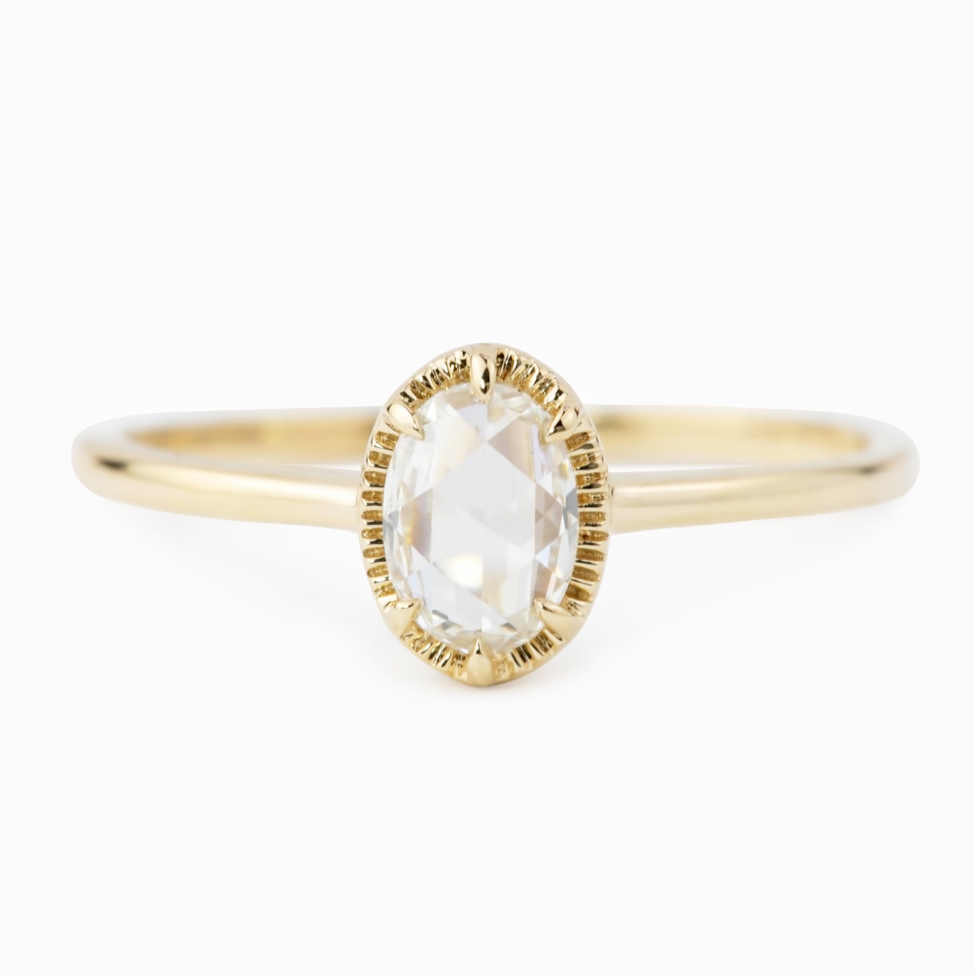 Oval rose cut diamond ring set in a recycled solid gold tapered band with a low profile six prong bezel setting.