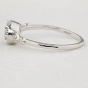 Close-up of 14k white gold Stella Ring with unheated 0.80ct blue sapphire and white accent diamonds in low profile bezel setting.