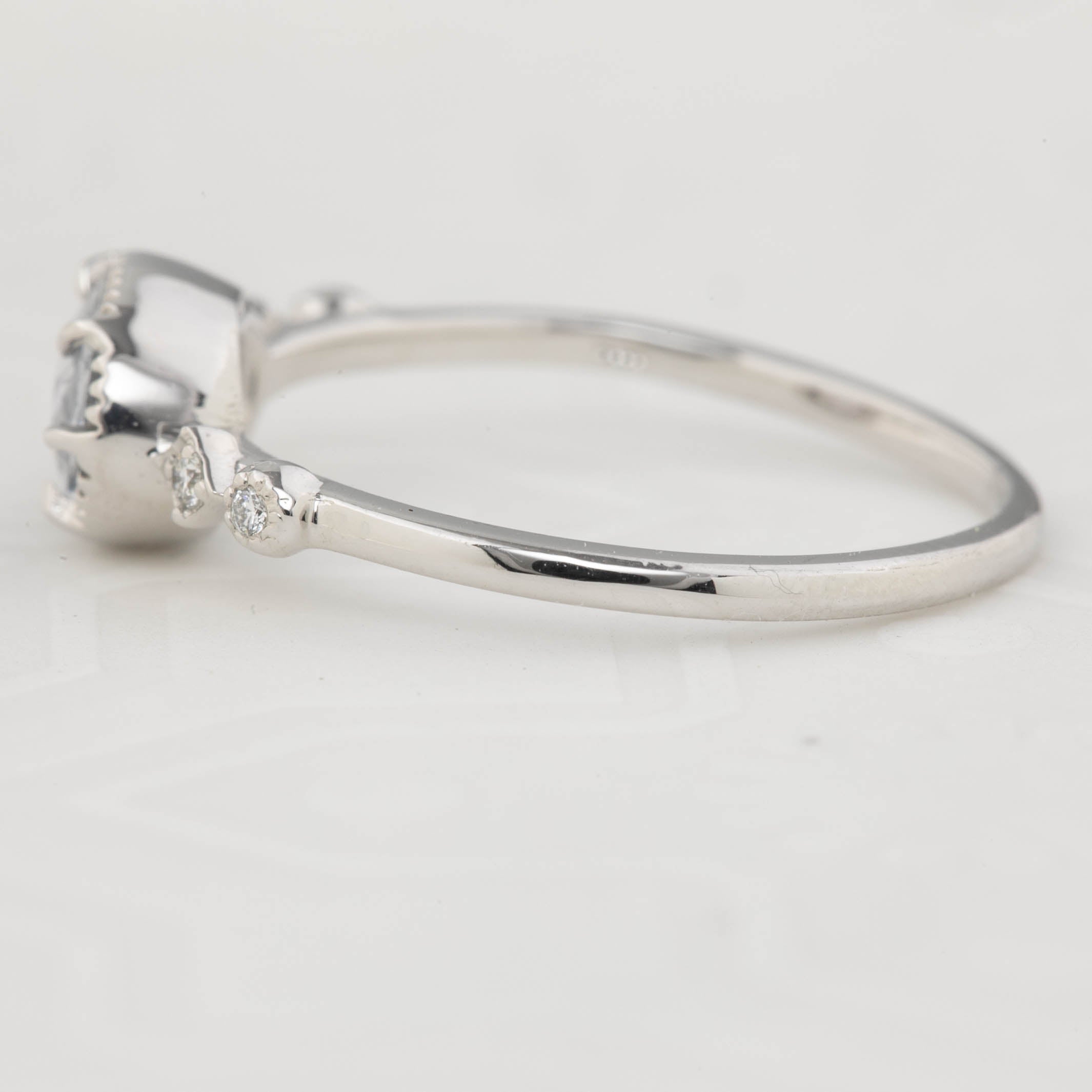 Close-up of 14k white gold Stella Ring with unheated 0.80ct blue sapphire and white accent diamonds in low profile bezel setting.