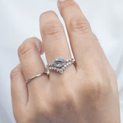 Hand wearing one of a kind Stella Ring with 0.80ct unheated blue sapphire and white diamonds in 14k white gold