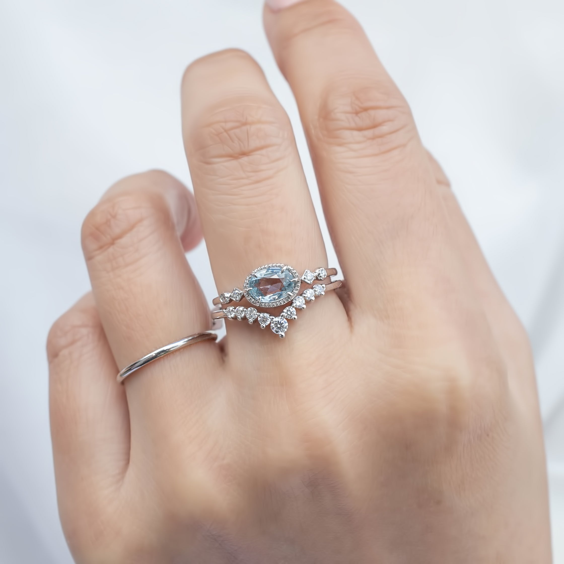 Hand wearing one of a kind Stella Ring with 0.80ct unheated blue sapphire and white diamonds in 14k white gold