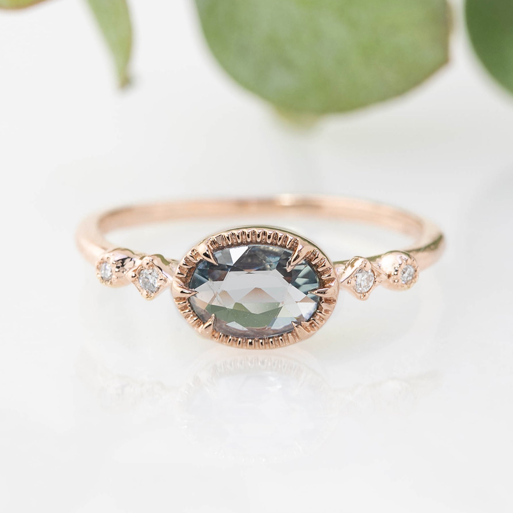 Rose gold Stella ring with 0.8ct oval blue sapphire and small white diamond accents on band