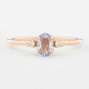 Three 'Estel Rings' with oval-shaped sapphires, in settings of 14k rose gold, 14k white gold, and 14k yellow gold, displayed against a light background., oval shape gemstone