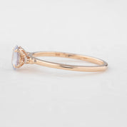 Three 'Estel Rings' with oval-shaped sapphires, in settings of 14k rose gold, 14k white gold, and 14k yellow gold, displayed against a light background., oval shape gemstone