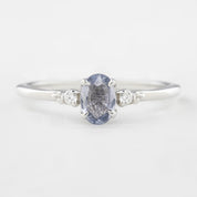 Three 'Estel Rings' with oval-shaped sapphires, in settings of 14k rose gold, 14k white gold, and 14k yellow gold, displayed against a light background., oval shape gemstone