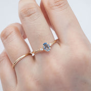 Three 'Estel Rings' with oval-shaped sapphires, in settings of 14k rose gold, 14k white gold, and 14k yellow gold, displayed against a light background., oval shape gemstone