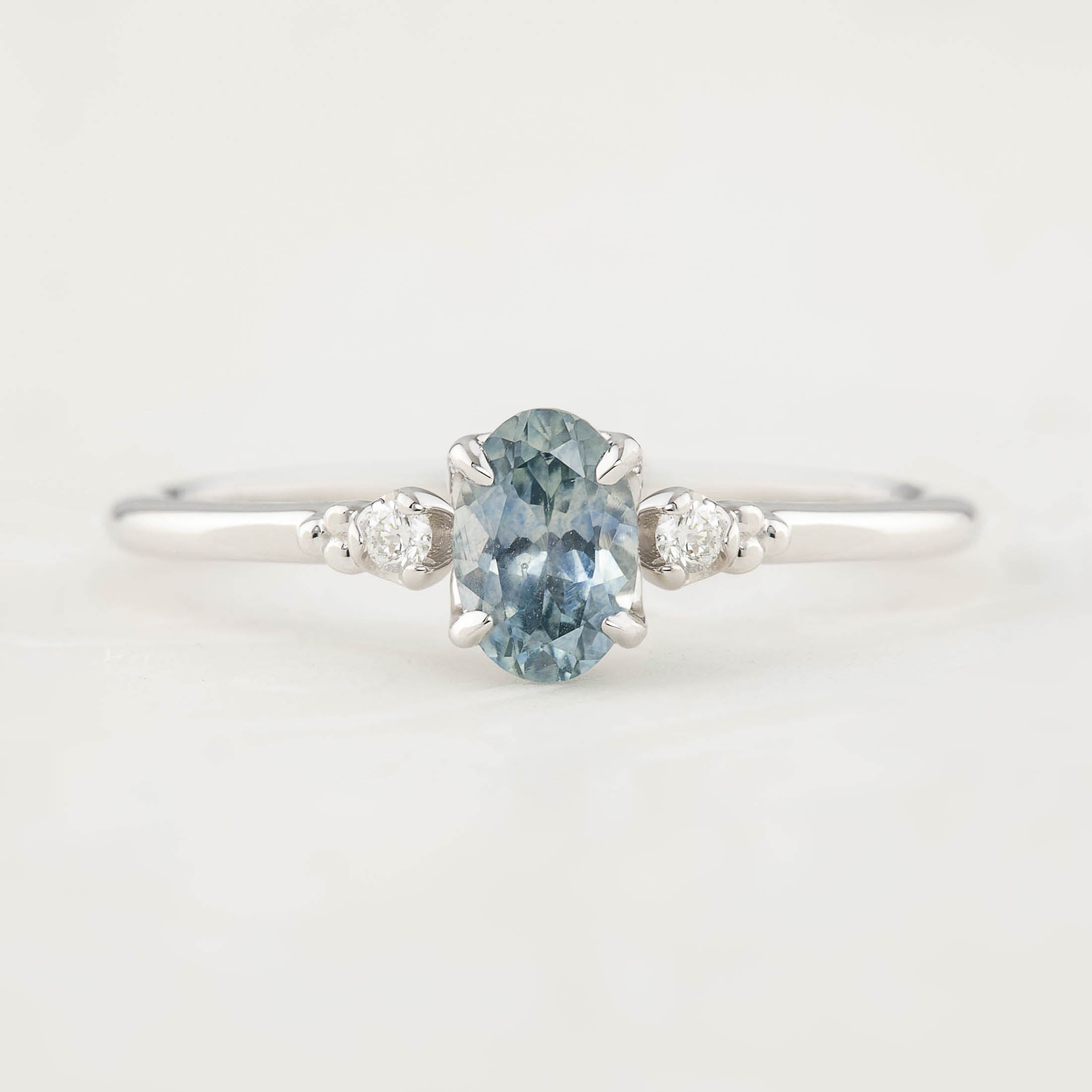Estel Ring featuring a 0.60ct blue-green oval Montana sapphire and natural diamond accents in 14k white gold