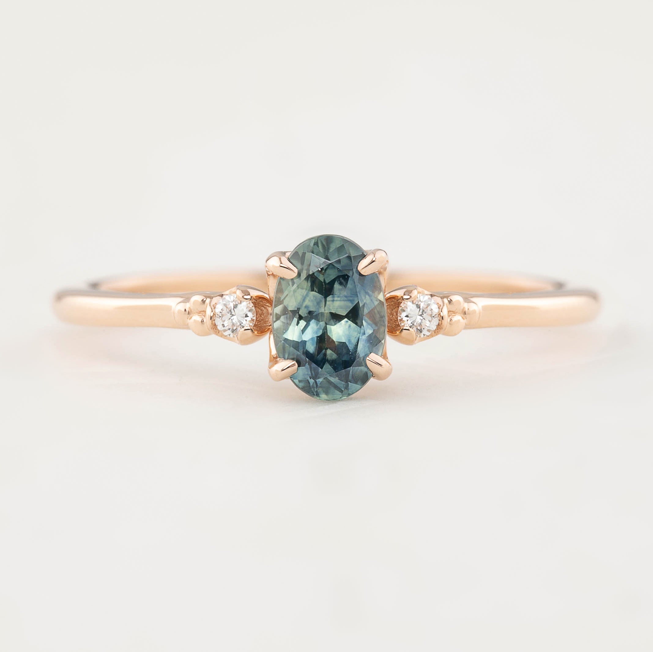 Estel Ring featuring a 0.60ct blue-green oval Montana sapphire and natural diamond accents in 14k rose gold