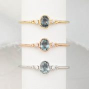 Three bezel set oval Madagascar sapphire ring with two natural diamond accents in a low profile 14k gold setting.