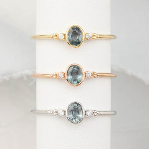 Three bezel set oval Madagascar sapphire ring with two natural diamond accents in a low profile 14k gold setting.