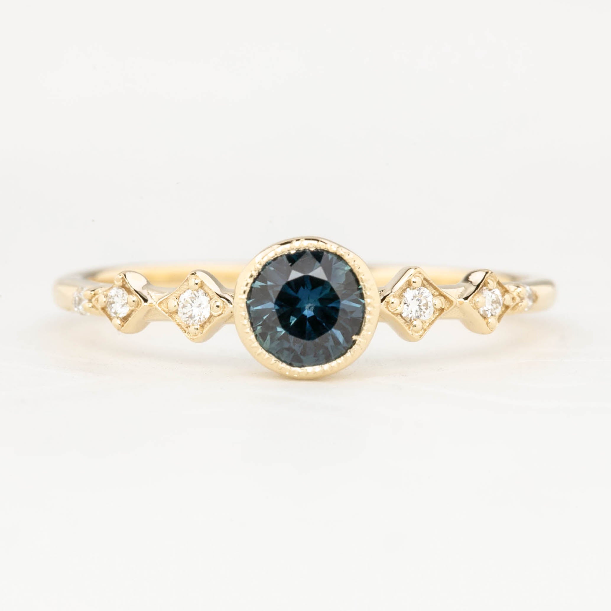 0.50ct teal blue Queensland Sapphire Ring in 14k yellow gold