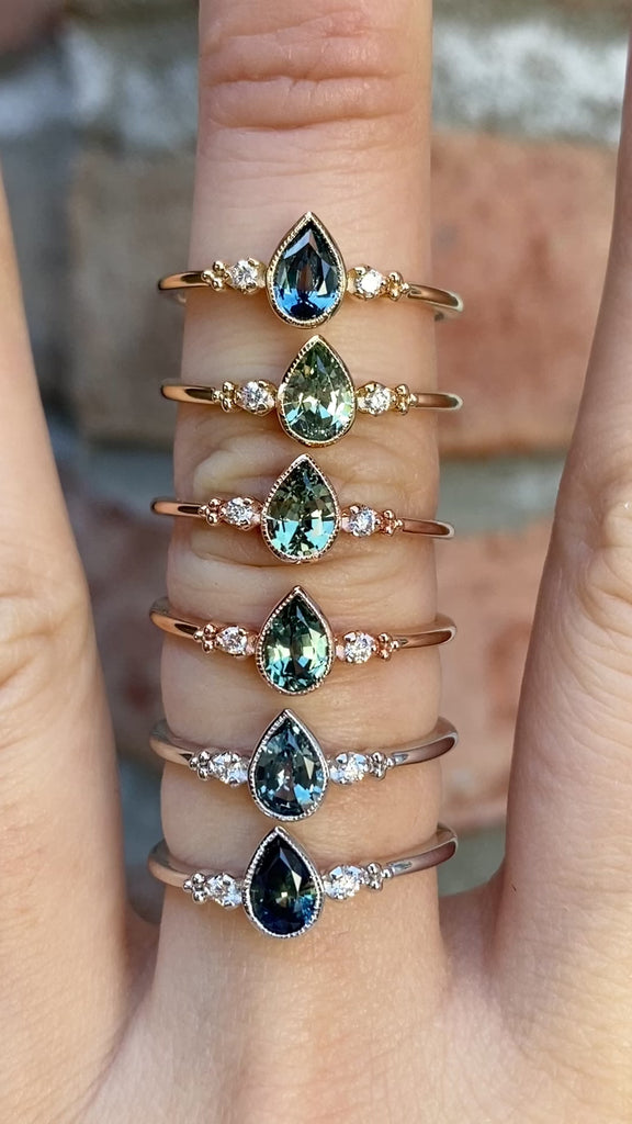 Estel Bezel Ring featuring a Pear Cut Montana sapphire and diamond accents. Low-profile 14k solid gold design. 6 ring options available.