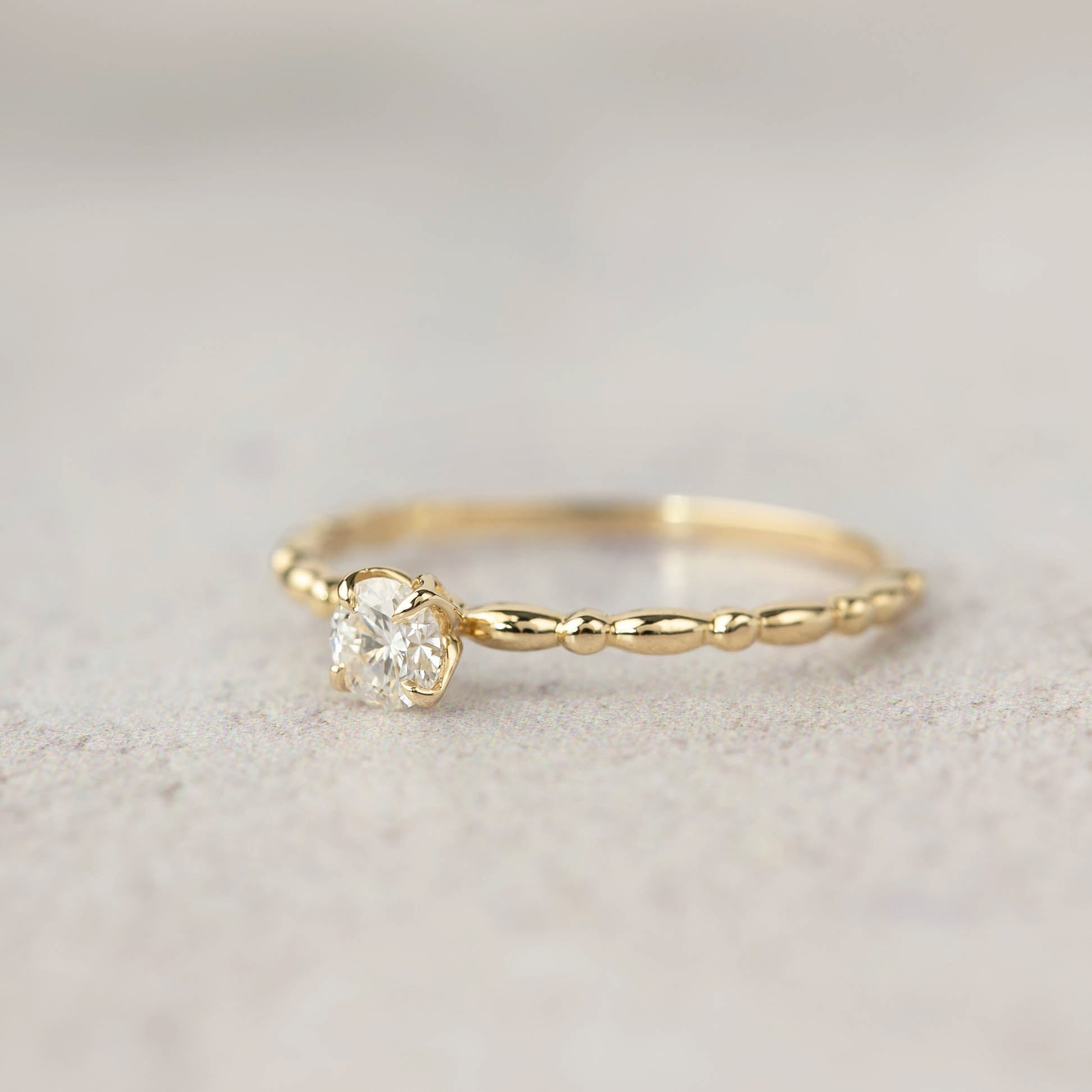 Delicate 14k yellow gold candy ring with 0.25ct round brilliant cut diamond in four prong flower setting