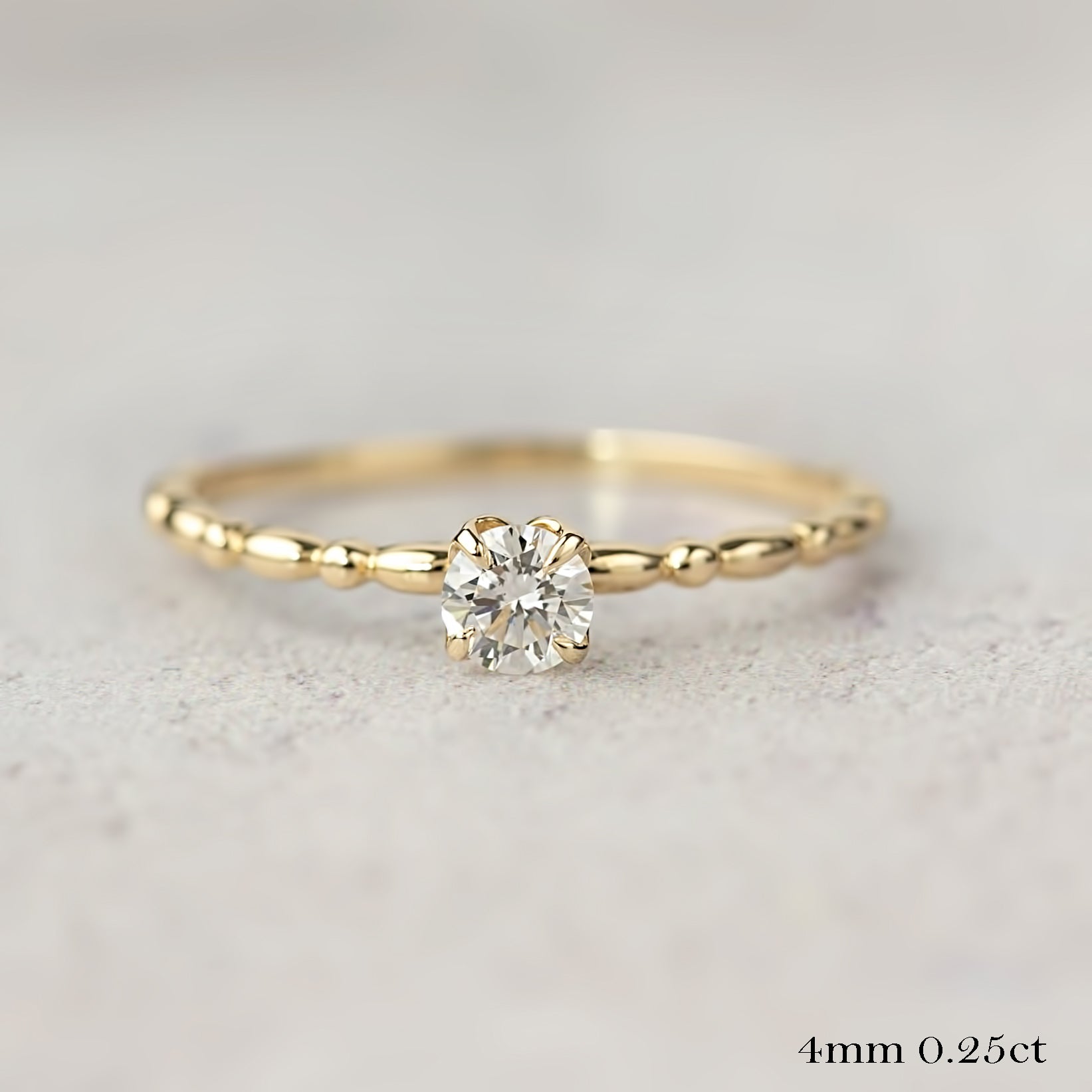 14k yellow gold candy ring with 0.25ct round brilliant diamond in flower setting on textured band