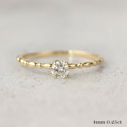 14k yellow gold candy ring with 0.25ct round brilliant diamond in flower setting on textured band