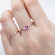 The Emilie 0.45ct Umba pink sapphire ring worn to show the unique horizontal orientation and rose gold band on hand.