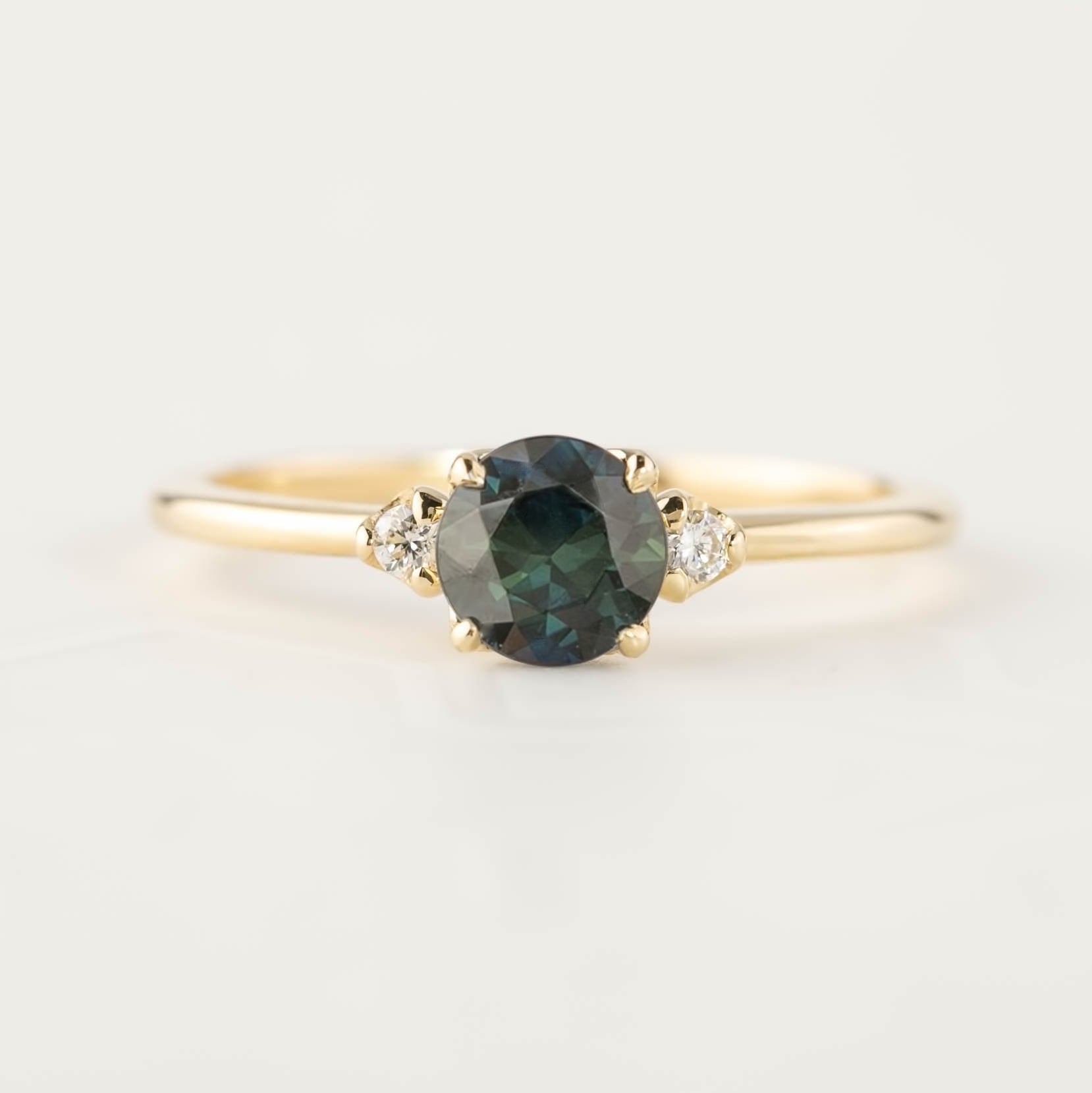Gold ring with 0.75ct Queensland Peacock Sapphire and two small white diamonds on tapered band
