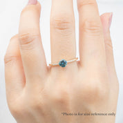 Audrey Ring, 0.73ct Queensland Sapphire with a green gemstone on a white background