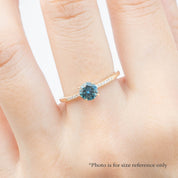 Audrey Ring, 0.73ct Queensland Sapphire with a green gemstone on a white background
