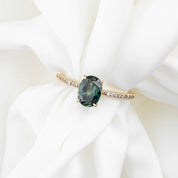 14k yellow gold ring with 1.53ct unheated oval green Queensland sapphire and small accent diamonds on band