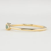 Side view of Emilie Ring featuring a 0.20ct East-West set oval Montana sapphire in 14k yellow gold.