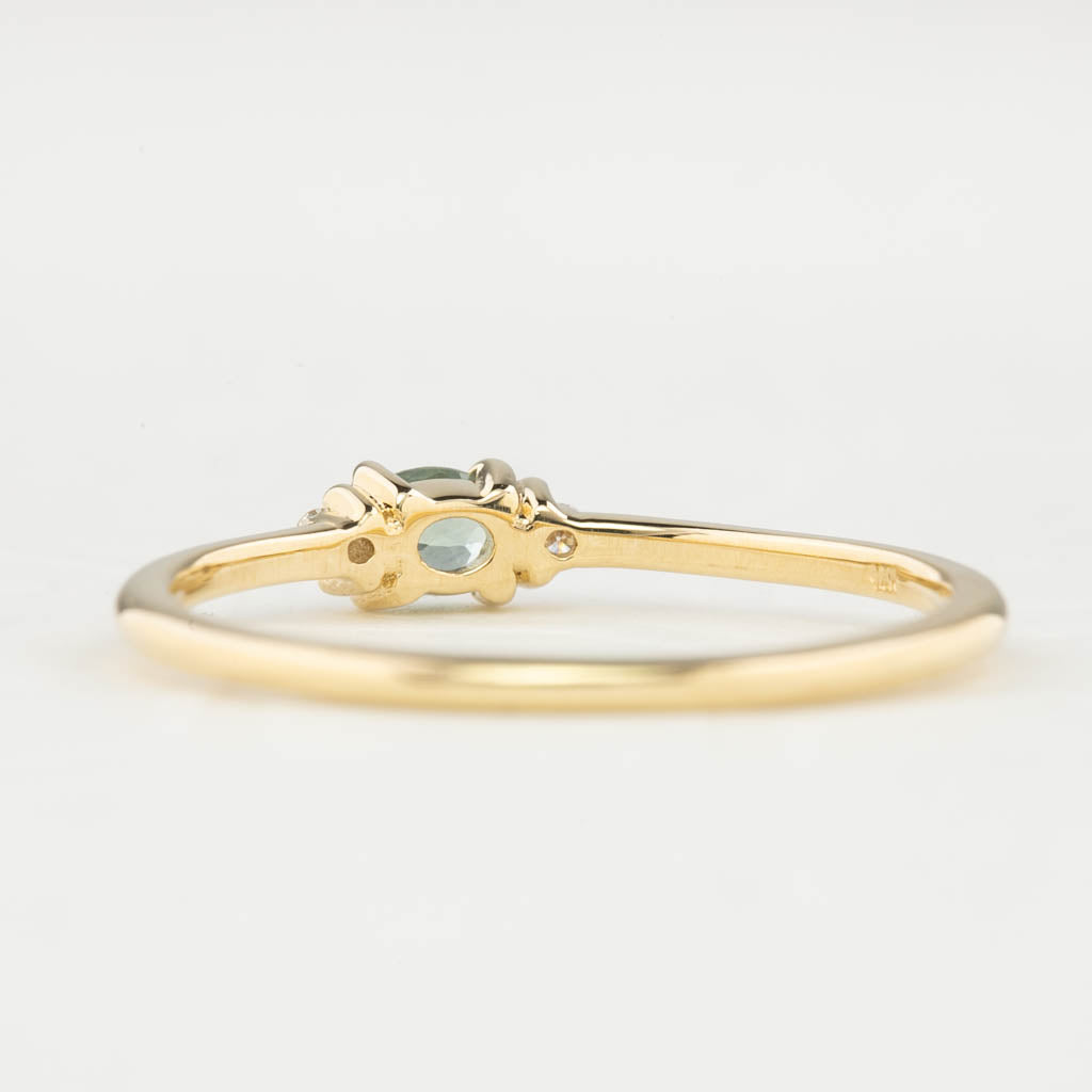 Back view of Emilie Ring featuring a 0.20ct East-West set oval Montana sapphire in 14k yellow gold.