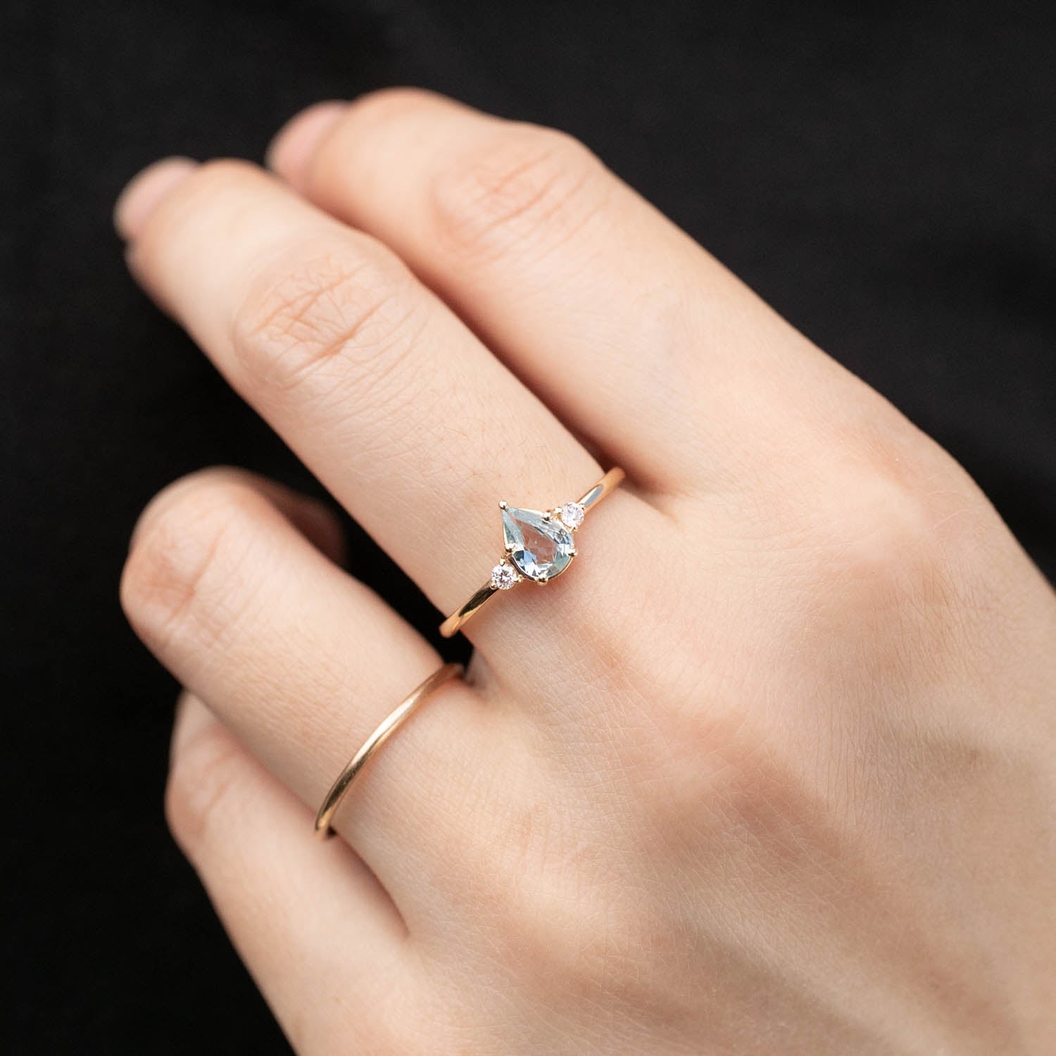 Emilie Ring featuring an unheated blue teardrop sapphire set in 14k rose gold, handmade and ethically sourced