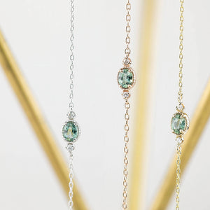 Three oval-shaped gemstone bracelets with accent diamonds, set in 14k gold and suspended from a gold cable chain.