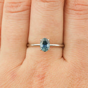Close-up of Sara Ring featuring 1.00ct parti blue green Montana sapphire set in 14k white gold on finger size 7