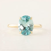 Oval blue zircon ring with checkerboard cut set in 14k yellow gold, size 7, elegant and resizable band design