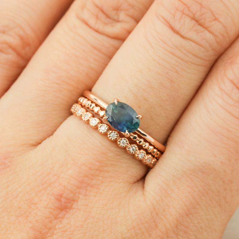 Close-up of Sara Ring featuring 1.00ct green Montana Sapphire in 14k rose gold with diamond accent bands.