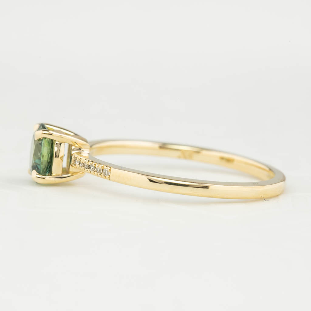 Audrey Ring, 0.73ct Queensland Sapphire with a green gemstone on a white background