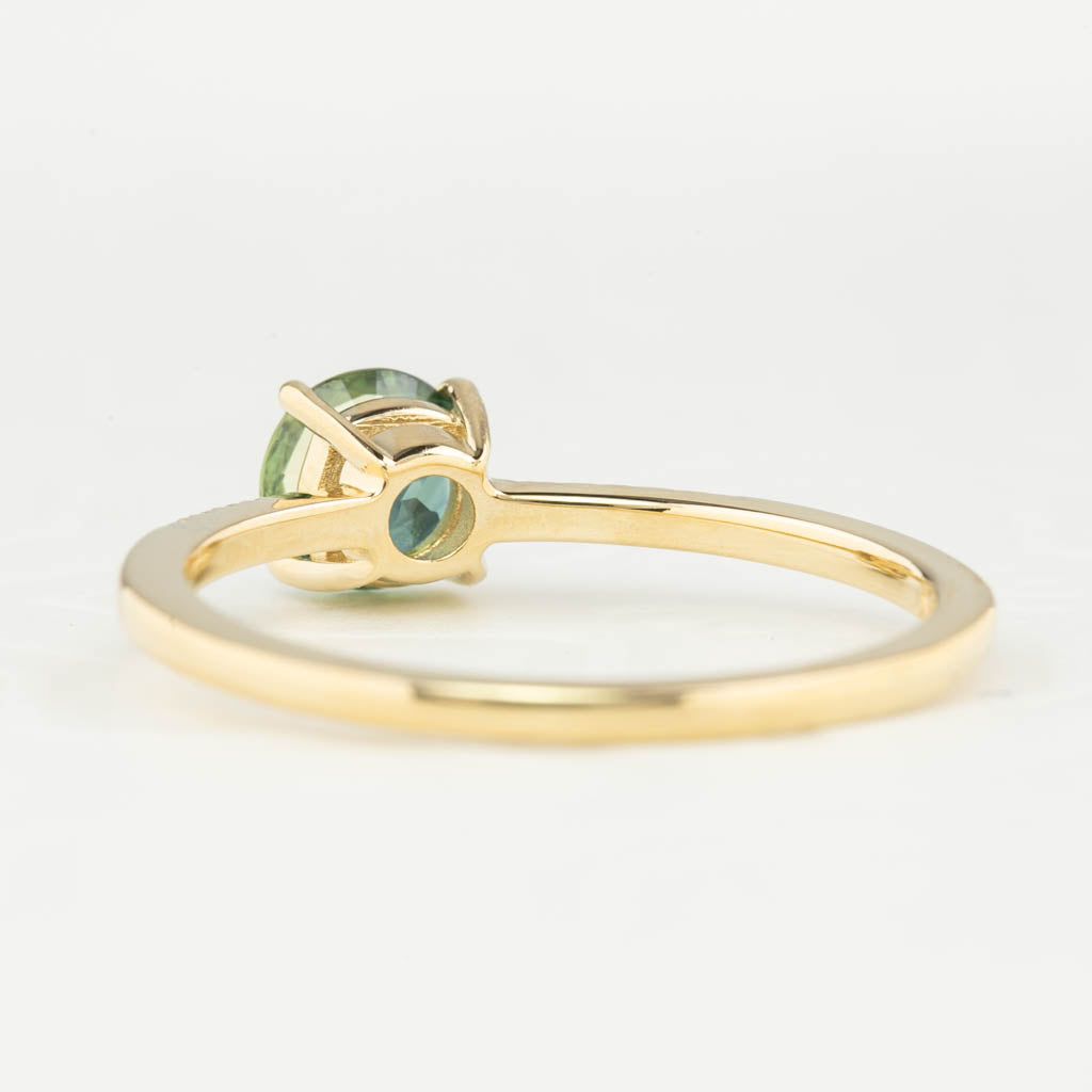 Audrey Ring, 0.73ct Queensland Sapphire with a green gemstone on a white background