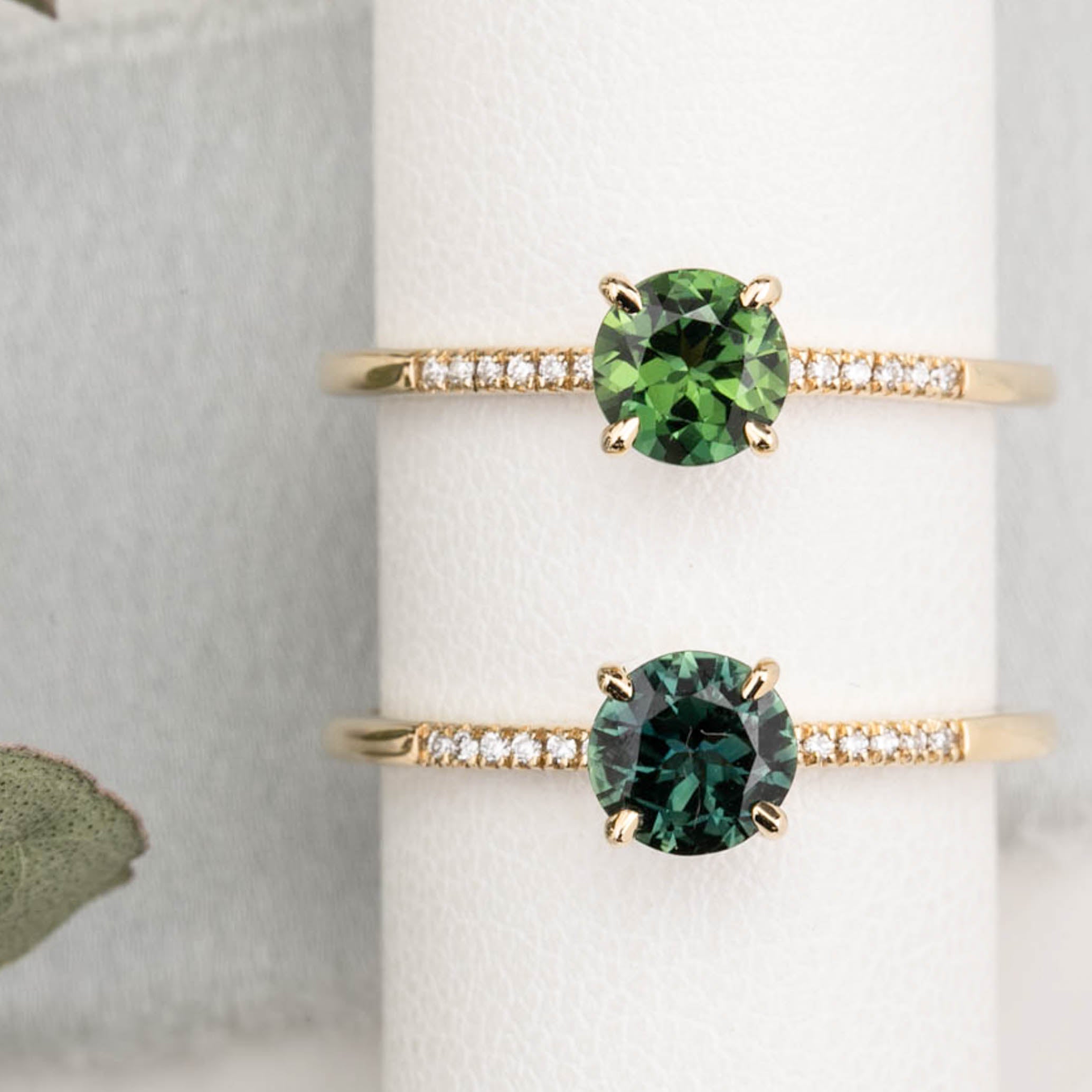 Audrey Ring, 0.73ct Queensland Sapphire with a green gemstone on a white background