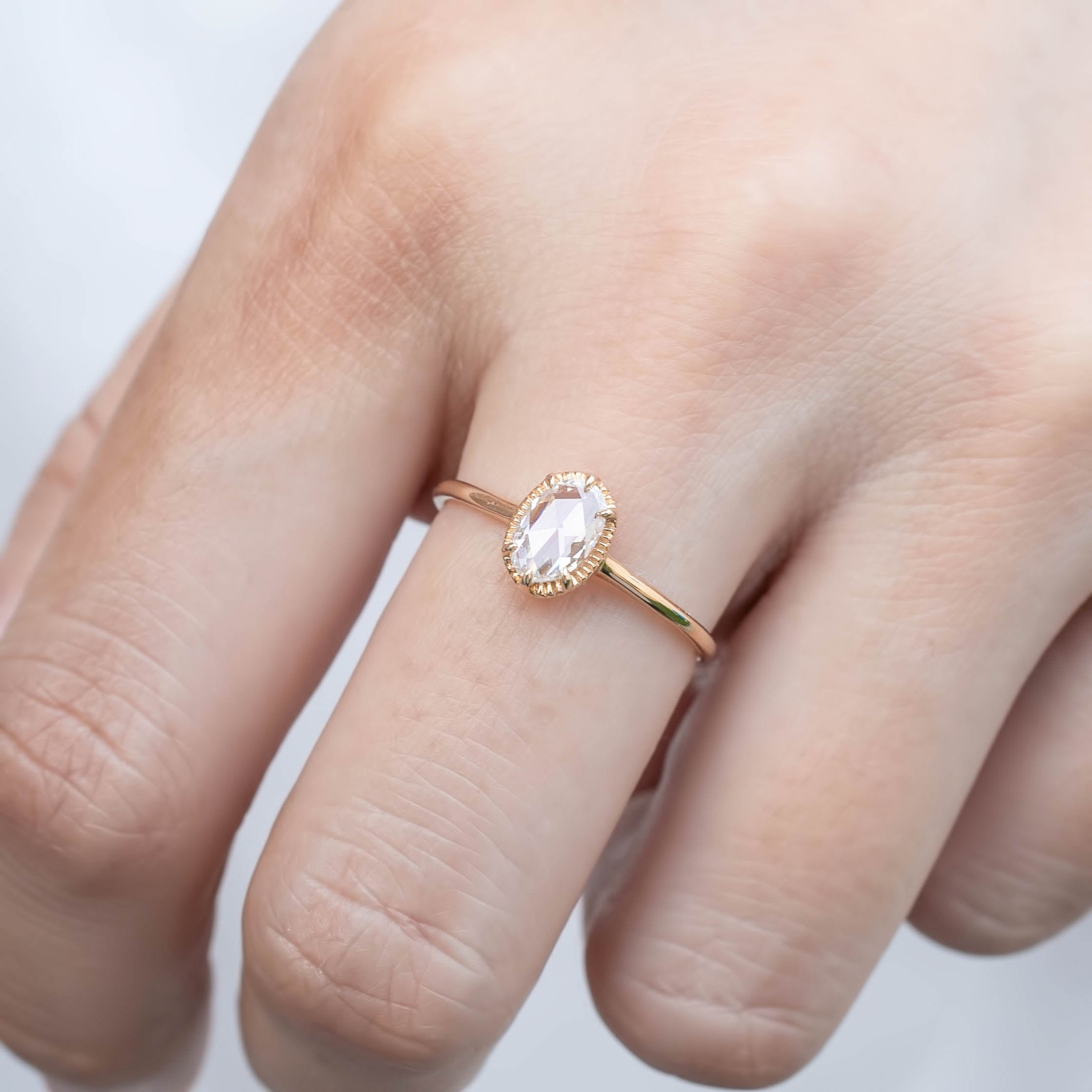 Ava ring featuring an oval rose cut diamond set in a delicate recycled gold tapered band.