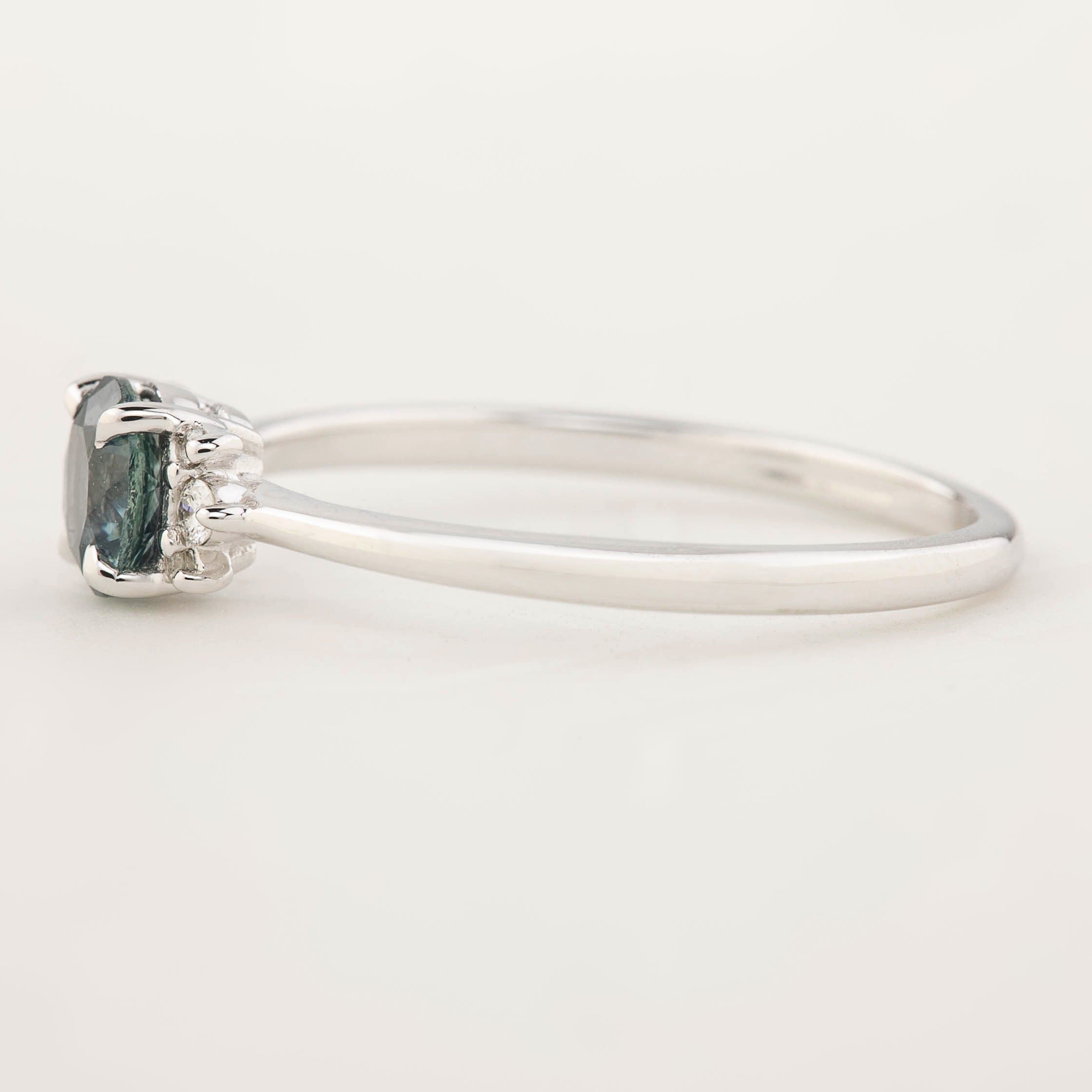Stunning Lena Ring featuring a 0.65ct blue-green Montana Sapphire, set in 14k white gold with sparkling accent diamonds.