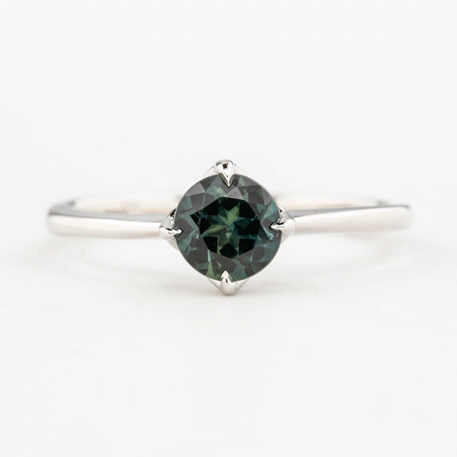 Alice Ring, 0.85ct Queensland Sapphire ring with a green gemstone on a white background