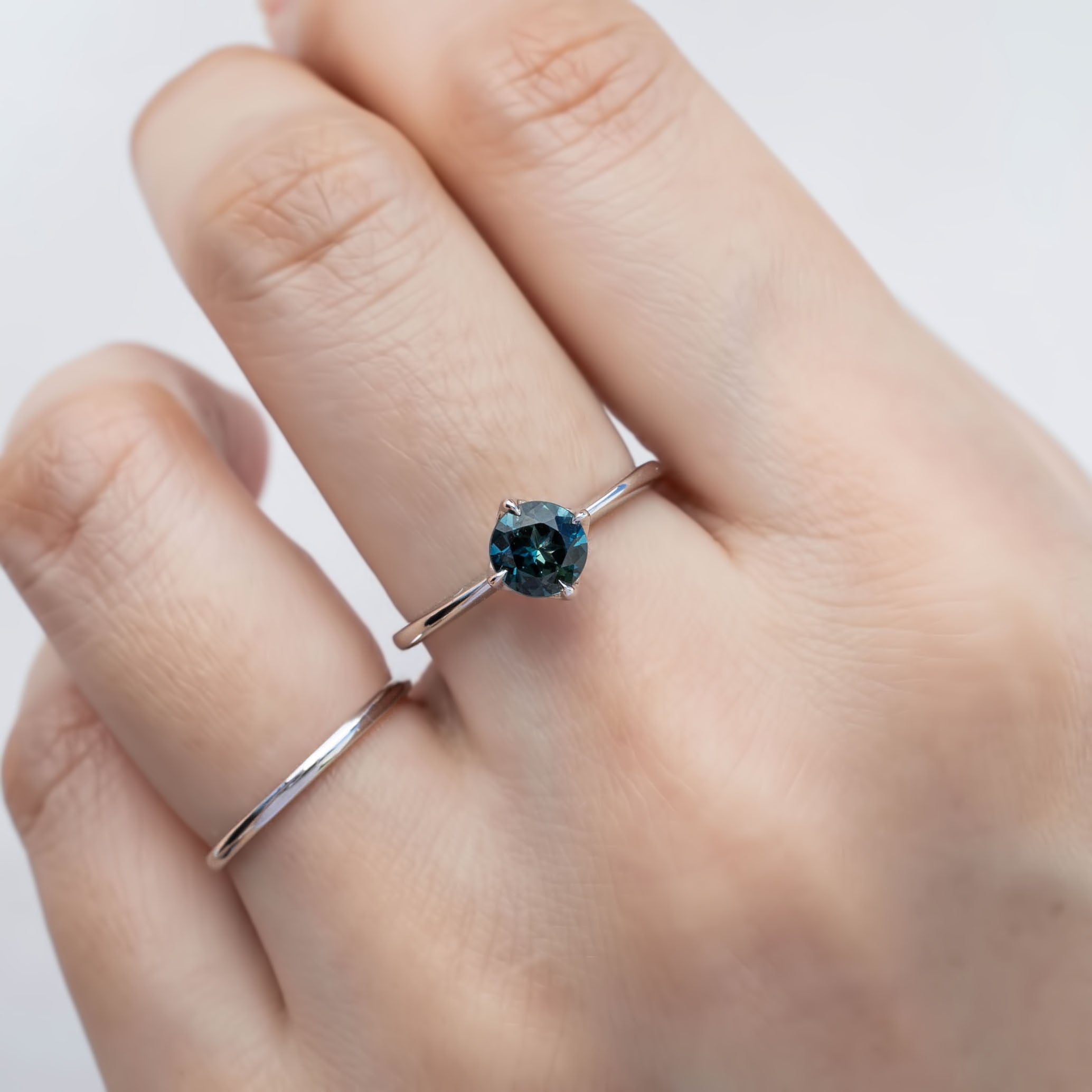 Alice Ring, 0.85ct Queensland Sapphire ring with a green gemstone on a white background