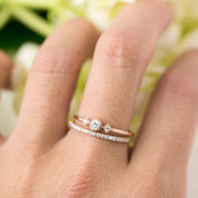 Close-up of a hand wearing a Meteor Diamond Band 1.3mm with natural white diamonds in rose gold.