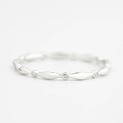 Close-up of Aria Eternity Ring featuring natural white diamonds set in a delicate solid gold band with a polished finish.