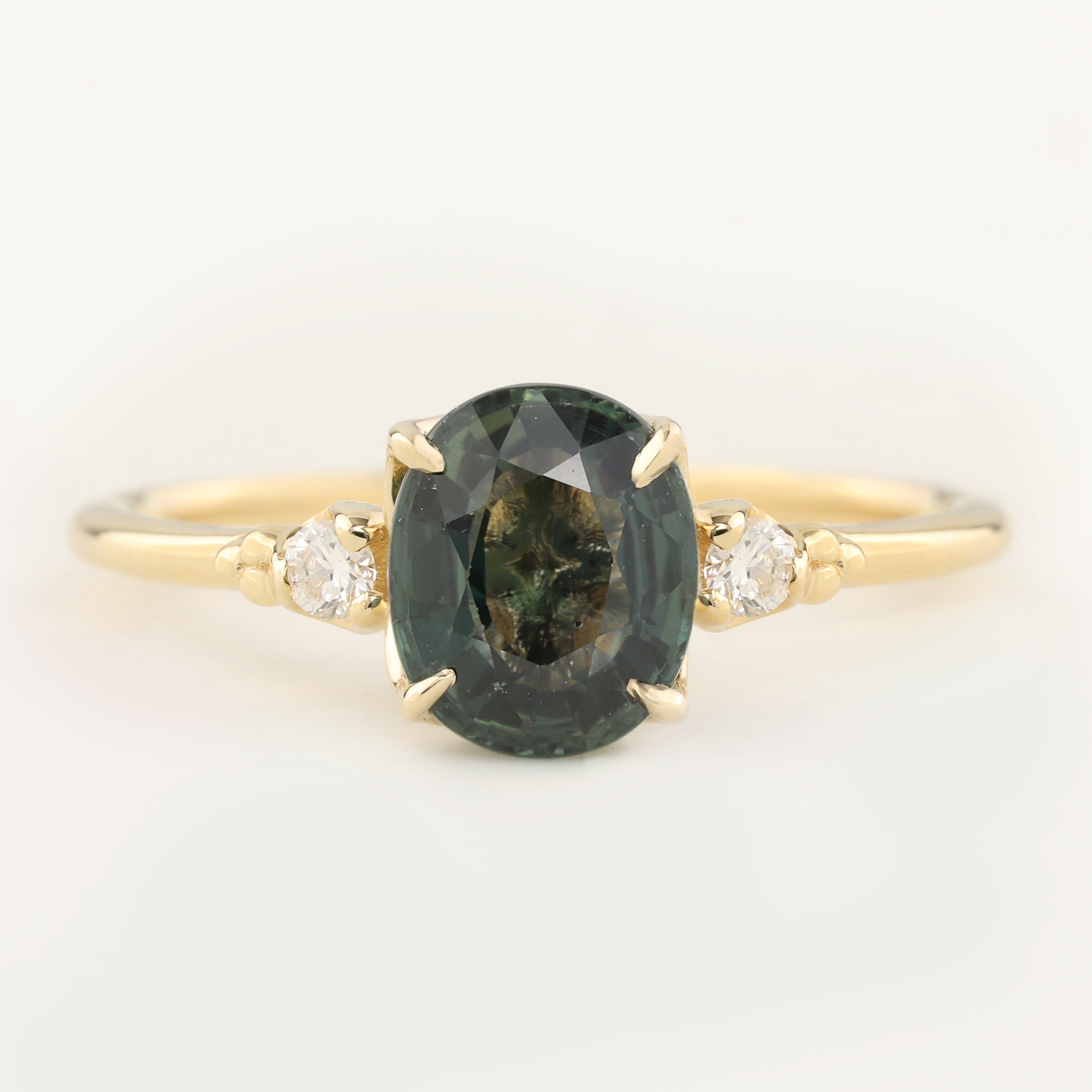Estel Ring featuring a 1.93ct green sapphire with white diamond accents in 14k recycled yellow gold, handmade and unique.
