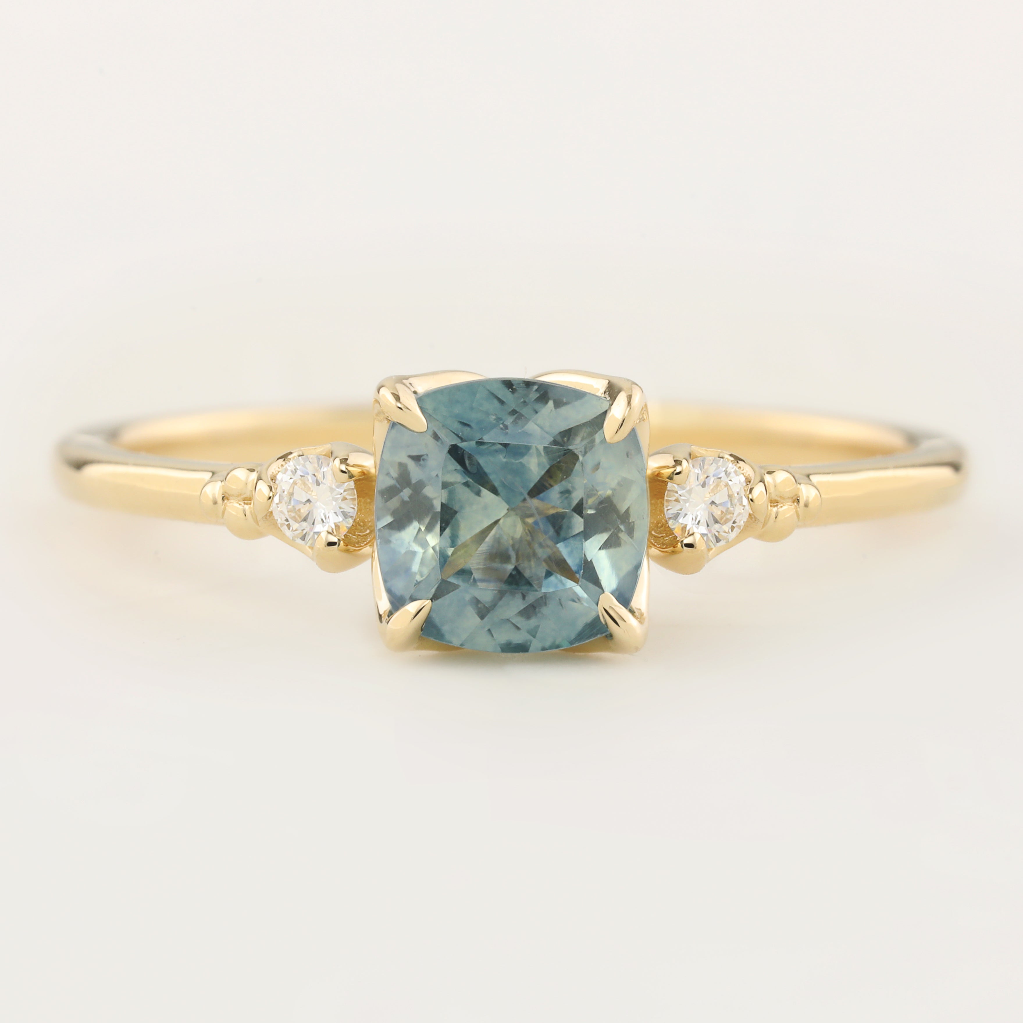Estel Ring with 1.07ct cushion cut light blue green Montana sapphire and white accent diamonds in recycled 14k gold